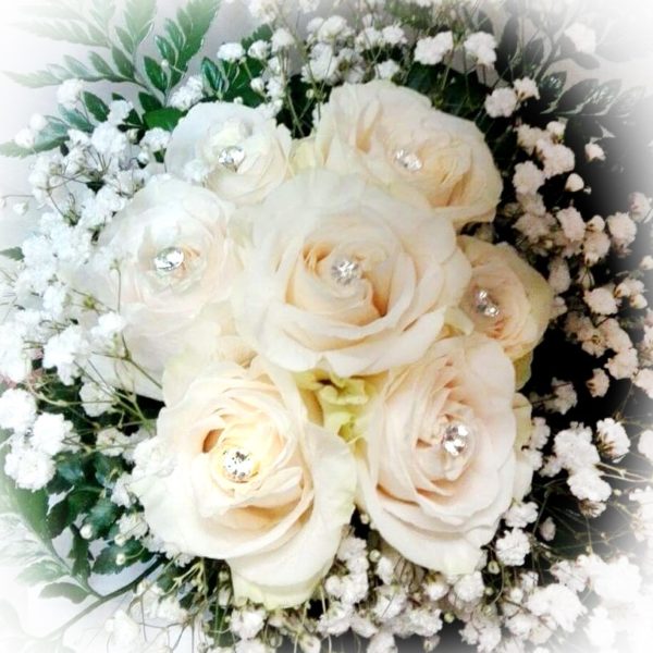 bouquet con rose bianche e punto luce su ogni bocciolo